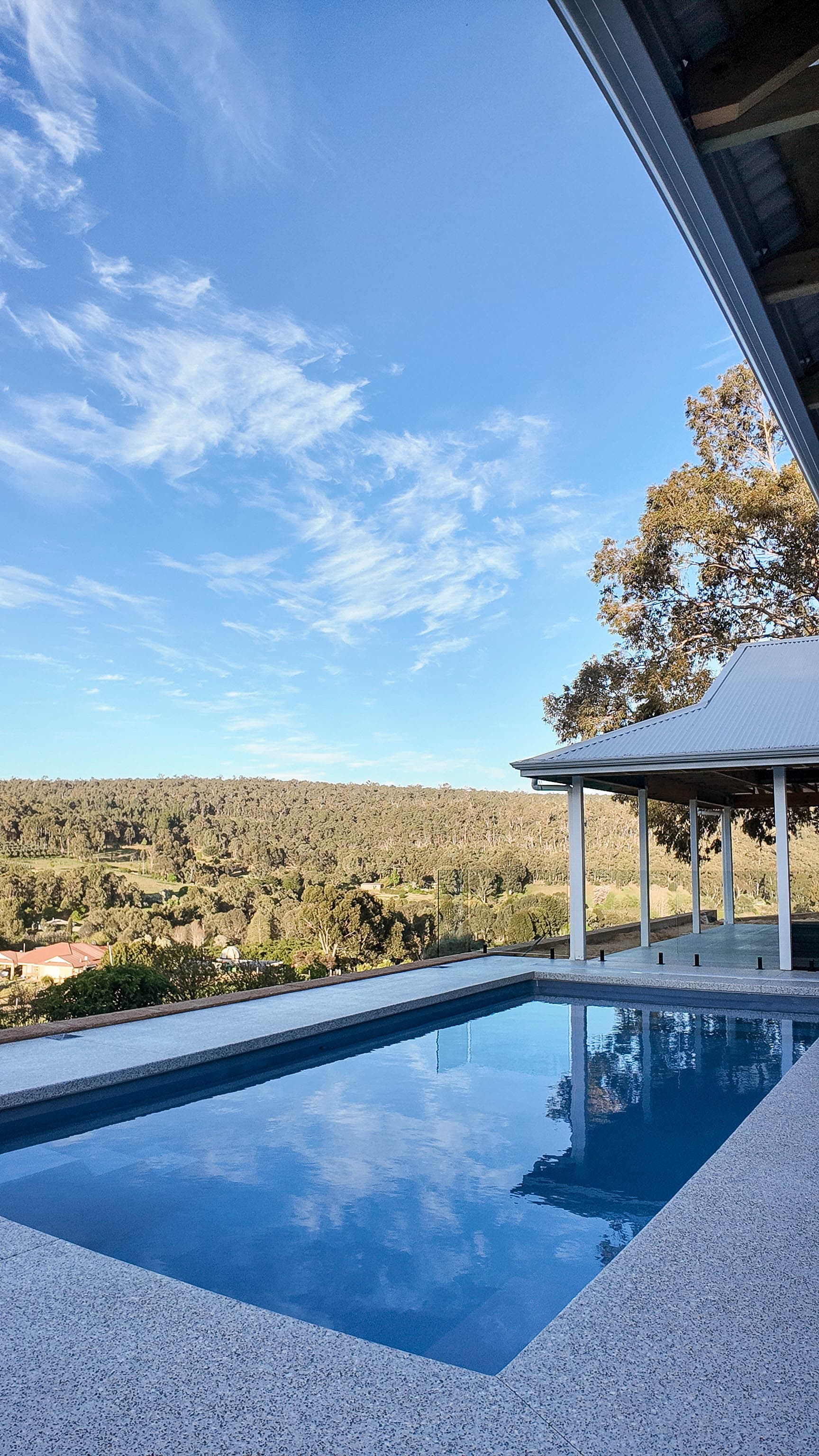 Drone perspective over completed pool and yard